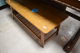 A vintage coffee table having stylised legs and spindle undertier with match rectangular top,