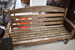 A wooden slatted garden bench, width approx. 153cm
