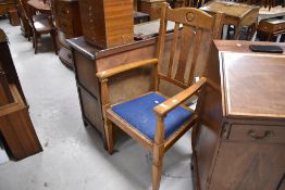 An early 20th Century golden oak carver chair, width approx. 58cm