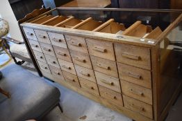 A vintage glazed shop counter having twenty four drawers (no top), dimensions approx. W165 H81