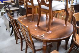 A modern table and set of six (four plus two) dining chairs