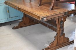 A 19th Century oak library style table having figural/mythical carving throughout, approx. 152 x