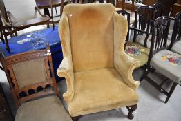A Georgian and later wing back armchair