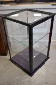 A late 19th or early 20th Century multi sided glazed shop or gallery display cabinet having ebonised