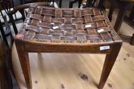 An Arts & Crafts oak and leather lattice work stool in the Arthur Simpson Handicrafts style,