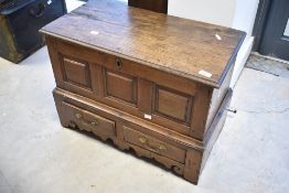 A period oak three panel kist of miniature specimen proportions having lift lid and two drawers to
