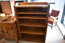 Workshop of Robert Mouseman Thompson of Kilburn; A golden oak bookshelf with carved mouse