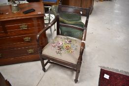 A 19th Century mahogany carver chair having drop in woolwork seat , stamped to front for Gillows
