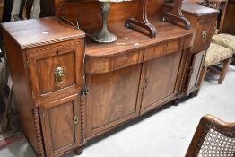 A 19th Century Regency design mahogany breakfront sideboard having lion mask handles, dimensions