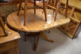 A modern pine rounded rectangular pedestal dining table with demi-lune leaves, 72cm x 151cm x 91cm