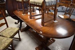 A nice quality modern oak extending dining table of oval form , on bulbous supports, together with