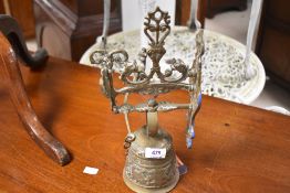 An antique brass wall mounted door bell, having figural design and lettering Qui Me Tangit Vocem