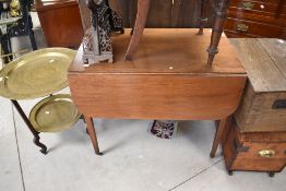 A Victorian mahogany pembroke table having square tapered legs and brass castors