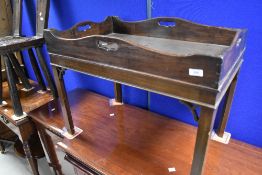 A traditional mahogany butlers tray on stand, dimensions approx. W74 D46 H57cm