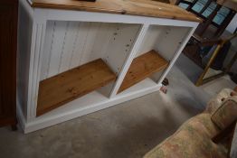 A modern pine and painted low bookshelf, dimensions approx. W153 H92 D31cm