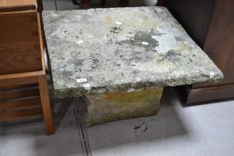 A natural stone garden table, dimensions approx. 62 x 67cm, height 42cm