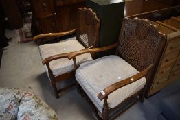 A pair of early 20th Century bergere back easy armchairs