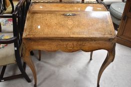 A 19th Century walnut and inlaid French ladies writing desk having brass gallery and