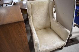A 19th Century arm chair having tapered legs and castors