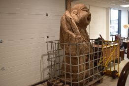 An impressive and monumental Chinese carved wooden Budai/laughing Buddha figure, modelled holding