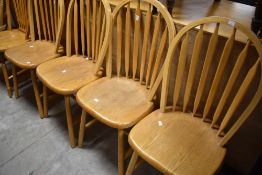 A set of four traditional lightwood kitchen chairs having hoop and rail backs, and a similar