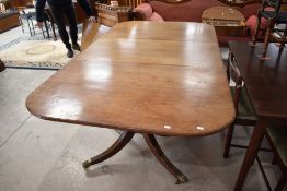 An early 20th Century Regency revival mahogany extending dining table of typical design, ends