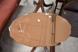A vintage frameless wall mirror having peach tint with etched desert island decoration, approx. 66 x