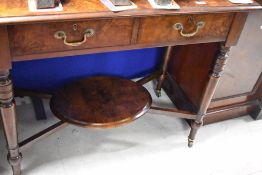 A Victorian walnut side table having double frieze drawer , turned legs and oval undertier,