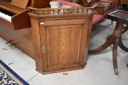 A Victorian oak corner cuboard having bobbin gallery , height approx. 90cm