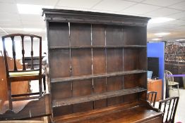 A period oak Welsh dresser and back, having delft rack over two drawer base with planked shelf