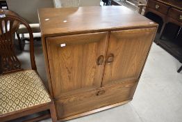A mid stain Ercol TV cabinet, approx. dimensions W84 x D52 x H94cm
