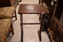 A pair of 19th Century mahogany nesting occasional tables having scroll feet and turned support