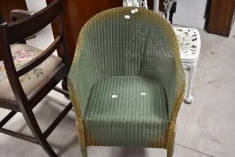A vintage Lloyd Loom tub chair, green on gold