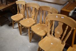 A set of four traditional beech fiddle back kitchen chairs