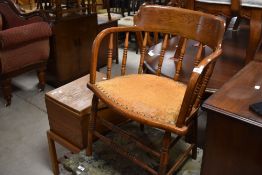 A late 19th or early 20th Century oak captains chair having turned supports and frame