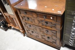 An early to mid 20th Century oak chest of four long drawers in the Jacobean style, dimensions