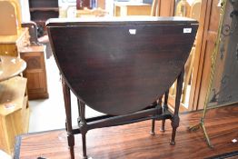 An early 20th Century mahogany occasional table in the Sutherland style having gate legs, width