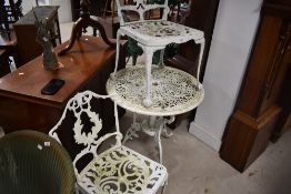 A painted cast alloy garden set comprising circular garden table, diameter 69cm , and two chairs