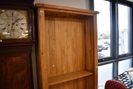 A modern golden oak bookshelf, dimensions approx. H202 W99 D33