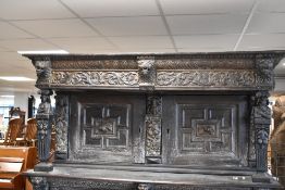 An impressive period oak court cupboard , with figural carving throughout including 'Jacob, Lia,