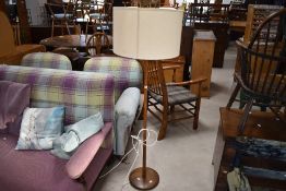 A traditional oak standard lamp having tapered column and disc base, height to fitting approx 115cm