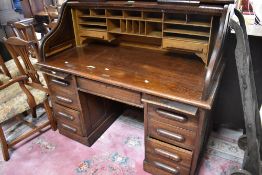 An early 20th Century oak roll top desk, labelled for Bentleys of Bradford , width approx 137cm,