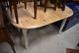 A traditional pine kitchen table having painted legs, the oval top approx. 137 x 89cm plue