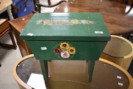A Romany style work stool having painted decoration and lift lid, wear to top, width approx. 41cm