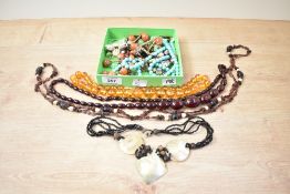 A collection of beaded necklaces, including circular amber beads, cherry amber imitation beads and