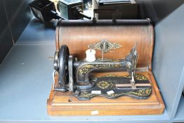 An early 20th-century Singer 'New Family' (model 12/12k) sewing machine, featuring a 'fiddle base'
