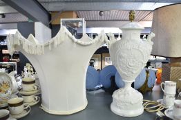 A large 20th-century Neoclassical-style white porcelain urn lamp base, featuring detailed high-