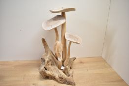 A large contemporary Indonesian hand carved parasite wood mushroom statue, compromising of four