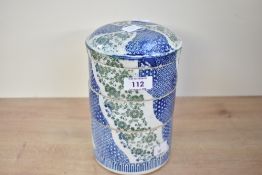 A 20th-century Japanese porcelain stackable bowl set, featuring three compartments of blue, green