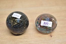 Two 20th-century studio art glass paperweights, to include a Wedgwood colourful abstract swirl